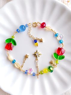 Looking to cosplay as Howl and Sophie this Halloween? I've got you!  This star charm bracelet inspired by howl's room handcrafted by AnavauCo, is especially perfect for cosplaying as studio ghibli characters, dressing up for a fancy events, attending a dinner party, or simply adding a touch of magic to your everyday look!  This bracelet also makes a great gift for your fellow studio ghibli film lovers~  Why this star chain dangle bracelet is a great fit for you... - Adjustable!   (3cm extension) Ghibli Gifts, Starburst Bracelet, Studio Ghibli Inspired, Ghibli Characters, Howl And Sophie, Studio Ghibli Characters, Bracelet Inspired, Dangle Bracelet, Howl's Moving Castle