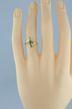 "14K Yellow Gold Emerald and Diamond Accent Ring, 3x5mm oval green center, 2 diamond accents, 9/16\" across ring, modernist bypass design, missing stone, Circa 1970, 2.5 grams Stock # BB231R21 Most rings are sizable for a small fee. If the ring you are considering is the incorrect size contact us for a quote. This listing contains photographs of the actual item you will receive. Our items are in excellent condition with little or no signs of wear and many are one of a kind pre-owned estate finds Modern Emerald Oval Cabochon Ring For Anniversary, Modernist Green Rings For Anniversary, Green Modernist Rings For Anniversary, Formal Green Oval Birthstone Ring, Vintage Green Marquise Emerald Ring, Fine Jewelry Oval Bypass Ring For Anniversary, Oval Emerald Ring With Tension Setting In Fine Jewelry, Oval Bypass Ring For Anniversary, Green Oval Modernist Jewelry