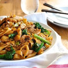 a white plate topped with pasta and veggies