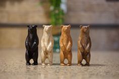 three small wooden bears standing next to each other