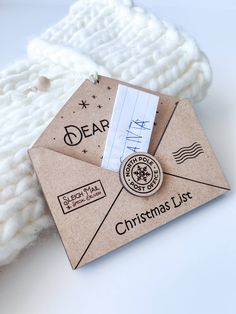 a close up of an envelope on top of a pile of white yarn and paper