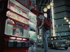 a man standing in front of a double decker bus with coca - cola on it