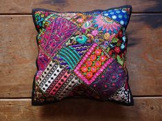 a colorful pillow sitting on top of a wooden floor