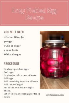 a jar filled with red liquid sitting on top of a wooden table next to an egg recipe