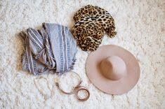 a hat, scarf and other items laid out on the floor