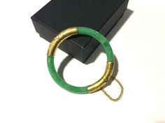 "FREE SHIPPING! Beautiful Vintage 1960's to 1970's (received as wedding gift and could be from the 40's or '50's or older, as they get passed down through family).  Apple green jade bangle 22k to 24k yellow gold wrapping, filigree engravings and safety chain.  This fits smaller wrist measuring 2 1/8\" or 53mm.  The width of the jade bangle is 9/32\" or 7.14mm. My belief is this apple green jade bangle is real jade and untreated due to age with normal inclusions and line fractures.  If this was color enhanced, it would definitely not last in color as there was no real technology.  The last picture shows the Chinese characters normally for this style.  This workmanship is rare. This is in very good condition considering wear and age.  When bracelet is open, there is a minor play at the hinge Vintage Jubilee Bracelet Jewelry For Ceremonial Use, Mid-century Yellow Gold Round Jewelry, Mid-century Round Yellow Gold Jewelry, Vintage Jewelry With Gold Clasp For Anniversary, Vintage Green Bangle For Wedding, Mid-century Bracelet Jewelry Gift, Collectible Hallmarked Bracelets, Vintage Anniversary Jewelry With Gold Clasp, Vintage Jubilee Bangle As Gift