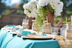 the table is set with mason jars and place settings