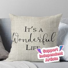 it's a wonderful life support independent artists throw pillow on a couch with pillows