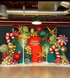 christmas decorations are displayed on the wall in front of a large sign that reads baltimore waterfront