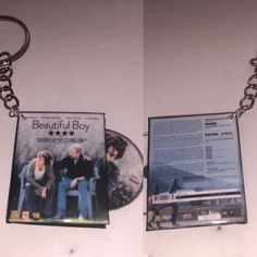 two dvd's sitting on top of each other in front of a keychain