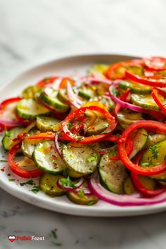 a white plate topped with sliced cucumbers and red onions