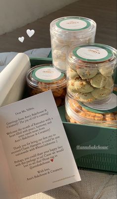 some cookies are sitting in a box with a note on the table next to it