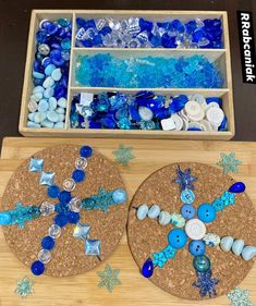 two wooden trays filled with blue and white buttons