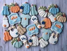 decorated cookies are arranged in the shape of an oven and pumpkins on a table