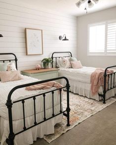 two twin beds in a bedroom with white walls