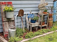 an assortment of garden tools and flowers in front of a house