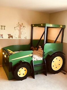 a bed made to look like a tractor with lights on the tires and headboard