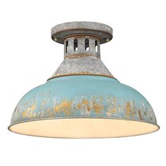 an old light fixture with rusted metal and blue paint on the bottom, against a white background