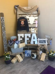 a chair made out of pallets with some items on it and the word fala written in large letters