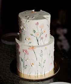 two tiered cake with flowers painted on it