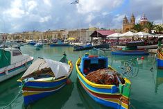 several colorful boats are docked in the water