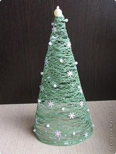 a small green christmas tree sitting on top of a table