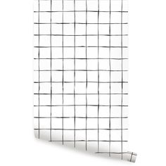 a black and white checkered wallpaper with a roll of paper on top of it