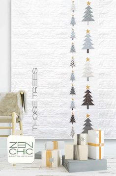 a white chair sitting in front of a christmas tree wall hanging