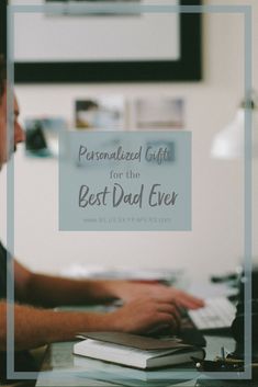 a man sitting in front of a computer on top of a desk with the words personalized gifts for the best dad ever