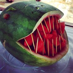 a watermelon that has been carved to look like a shark's mouth