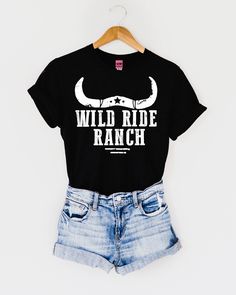 Saddle up cowgirl and lasso in our Wild Ride Ranch western graphic tee for women. Wild Ride Ranch western graphic tee by Ali Dee features a unisex fit body in black with white screen printed art. Sizes: S-3XL Chart in inches: Black Western Tops For Summer, Black Western Style Summer Tops, Black Western Style Tops For Summer, Graphic Tee With Screen Print For Western-themed Events, Trendy Black Tops For Rodeo, Western Style Screen Print Tops For Western-themed Events, Western Tops With Screen Print For Western-themed Events, Black Graphic Print Top For Rodeo, Black Western Top With Graphic Print