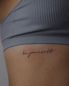 a woman's stomach with the word happiness written on it, in cursive font