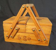 a wooden box with metal studs on the top and bottom, sitting on a black background