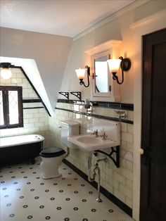 a bathroom with black and white tile flooring next to a bathtub, toilet and sink