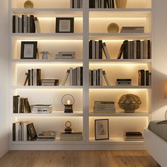 a white book shelf filled with lots of books next to a night stand and lamp