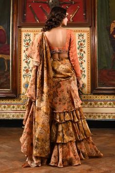 Peach and gold pre-draped saree with floral print and soft ruffles detailing. Paired with gota, sequins and moti embroidered solid blouse. - Aza Fashions Festive Silk Lehenga With Ruffles, Festive Ruffled Silk Lehenga, Silk Blouse Piece With Ruffles For Reception, Festive Silk Blouse With Ruffles, Silk Ruffled Blouse Piece For Reception, Traditional Silk Pre-draped Saree With Ruffles, Silk Choli With Ruffles For Reception, Festive Silk Blouse Piece With Ruffles, Designer Silk Lehenga With Ruffles