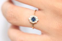 "Sapphire Ring / 14k Gold Round Sapphire Halo Wedding Ring / Halo Engagement Ring / September Birthstone Ring / Wedding Gold Diamond Ring Item Details * Made to Order * Gold Kt: 14K Solid Gold * Custom Gold Color: Rose Gold, Yellow Gold, White Gold * Round Diamond: 2 pcs pc 2.00MM * Round Diamond: 4 pc 1.75MM * Round Diamond: 6 pc 1.25MM * Round Sapphire: 1 pc 5MM * Total Number of Stones: 6 * Total Diamond CTW: 0.21 Ctw * Total Sapphire CTW: 0.40 Ctw * Diamond Color-Clarity: G Color Si1 Clarity Gold Sapphire Diamond Ring With Halo Design, Fine Jewelry Cluster Wedding Jewelry, Dainty 14k Gold Cluster Ring With Halo Setting, Wedding Cluster Ring With Center Stone In 14k Gold, 14k Gold Wedding Cluster Ring Fine Jewelry, Cluster Gemstone Diamond Ring For Wedding, Wedding Cluster Diamond Ring With Gemstone, Fine Jewelry Wedding Halo Ring With Center Stone, Heirloom 14k Gold Cluster Ring For Wedding