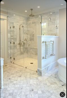 a large bathroom with a walk in shower next to a tub