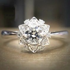 an old - fashioned diamond ring is displayed on a table