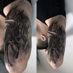 the man is showing off his tattoos on his thigh and leg, while he stands in front of an image of a horse