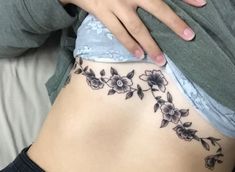 a woman's stomach with flowers on it and the bottom part of her stomach