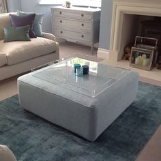 a living room with two couches and a coffee table in front of a fireplace