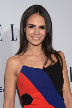 a woman in a colorful dress smiling for the camera