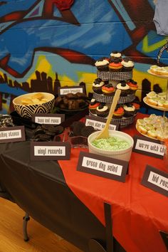 a table topped with lots of food and desserts on top of it's tables