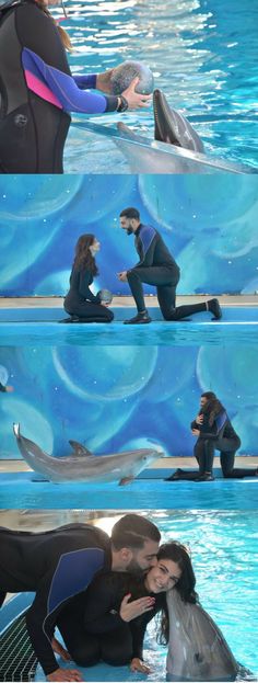 two people in wetsuits sitting next to each other near a dolphin swimming pool