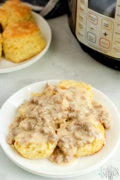 biscuits and gravy on a white plate next to an instant pressure cooker