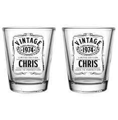 two shot glasses sitting next to each other on a white background with the words vintage 1974