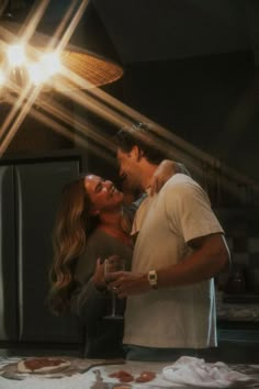 a man and woman standing next to each other in front of a refrigerator freezer