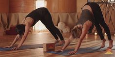 two women doing yoga poses on their mats