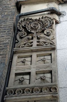 an ornately carved window on the side of a building